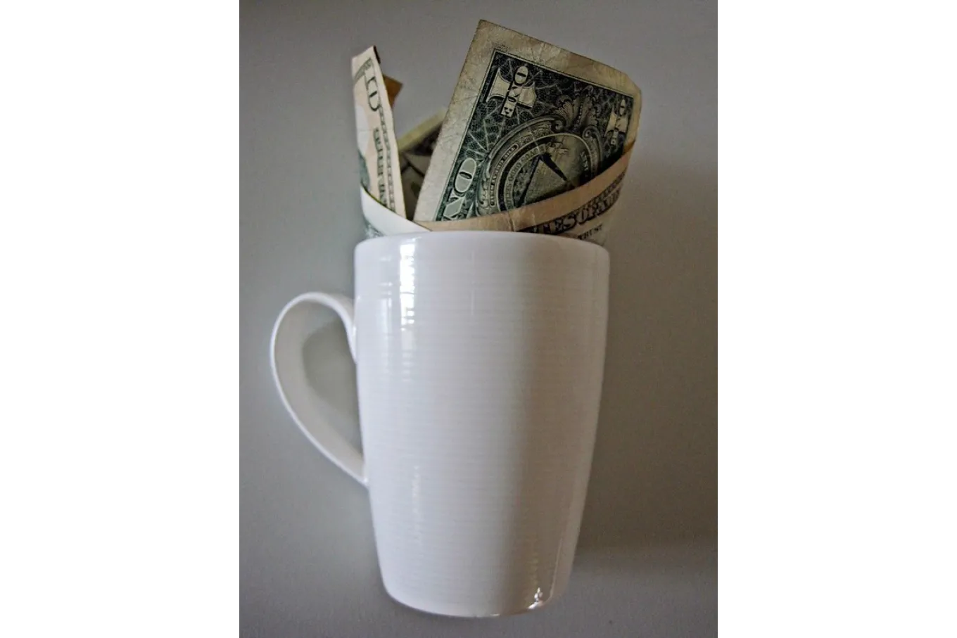 Coffee cup with money in it