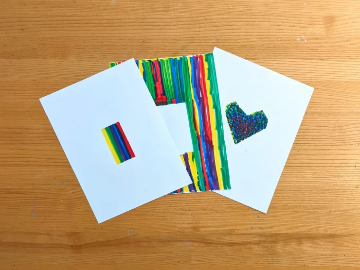 Photo of three colorful examples of coloring with negative space
